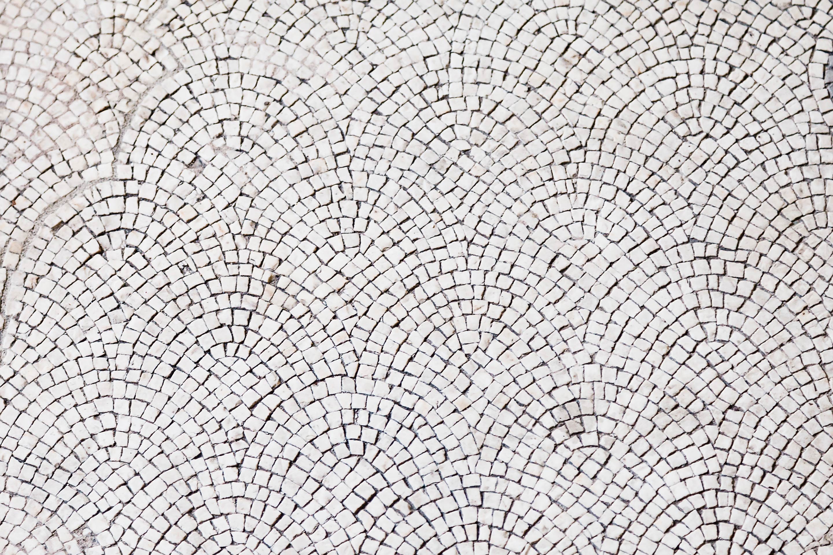 Overlapping stone tiles in a repeating pattern representing community.