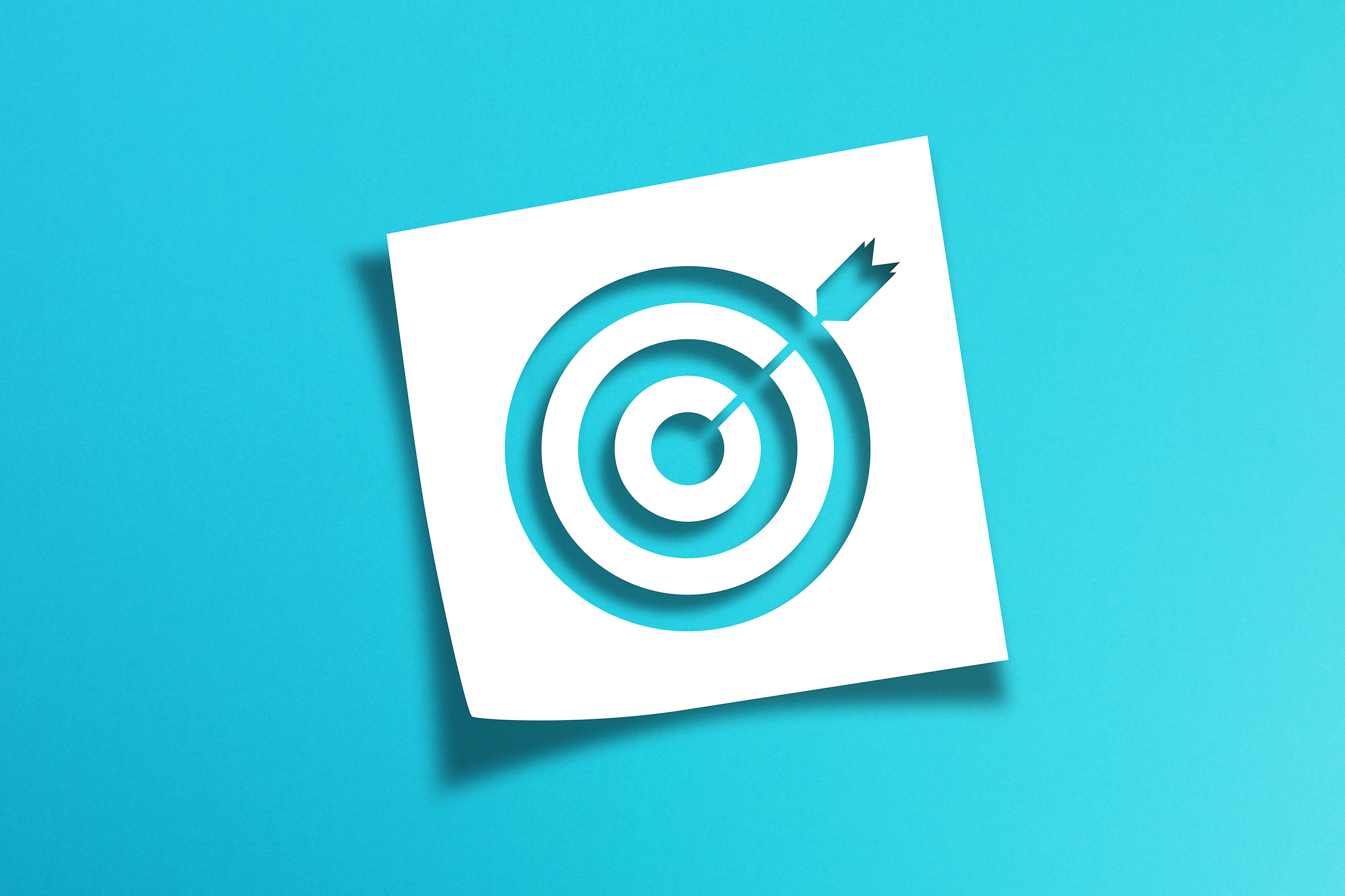 Image of a target on a vibrant blue background as a metaphor for investing goals