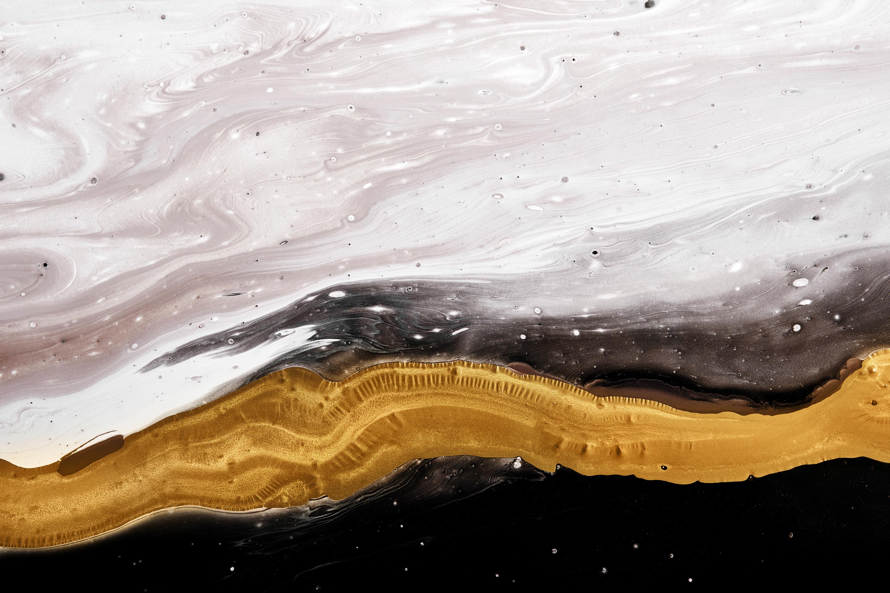 A crystal geode includes white, gold, and black ribbons of color representing interactivity.
