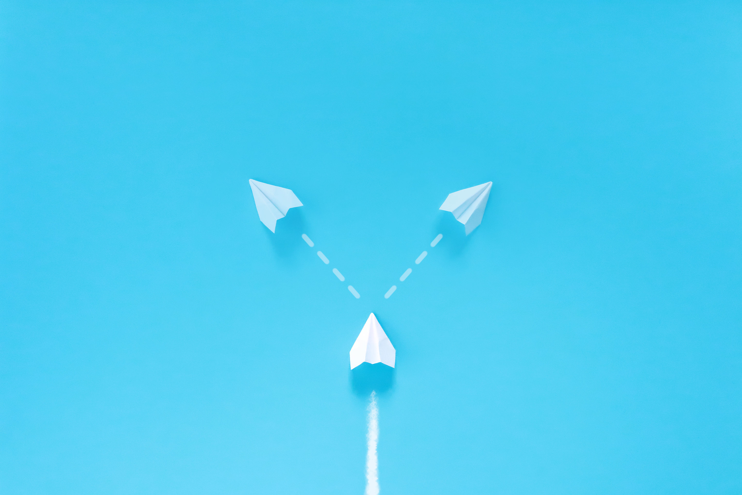 Image of white arrow on blue background, and facing a crossroad about whether to go left or right as a metaphor for considering investment decisions