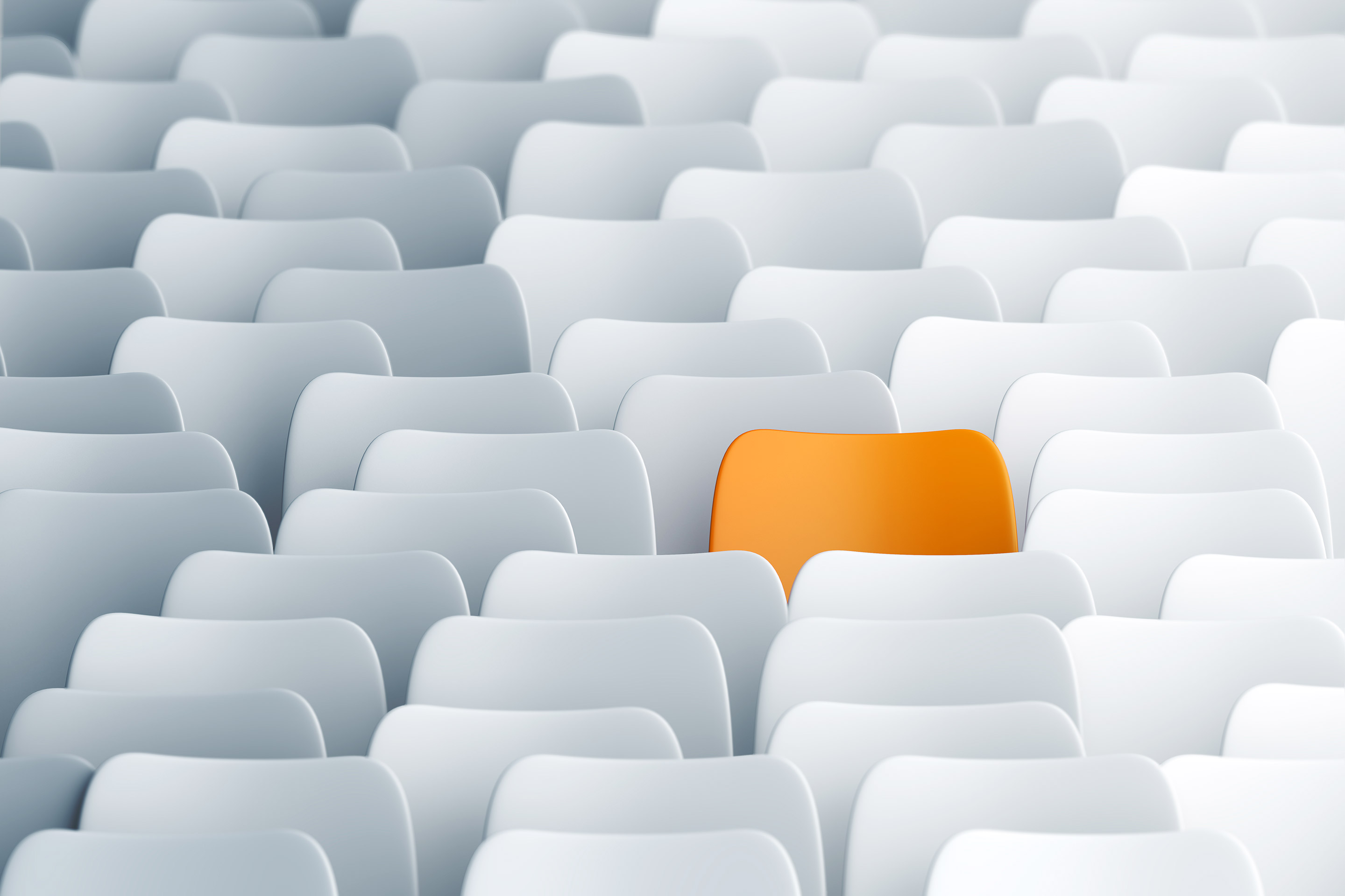 A single orange chair in a group of stark white chairs is certainly unpredictable.
