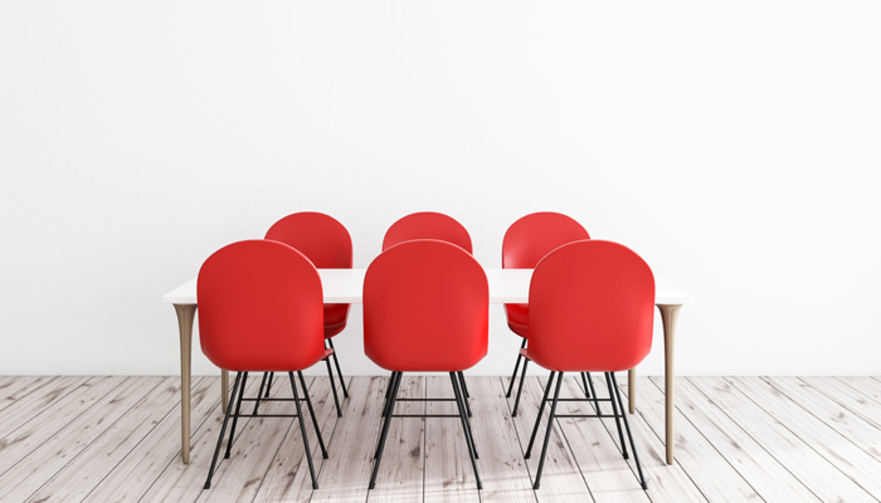 Six red chairs around a table