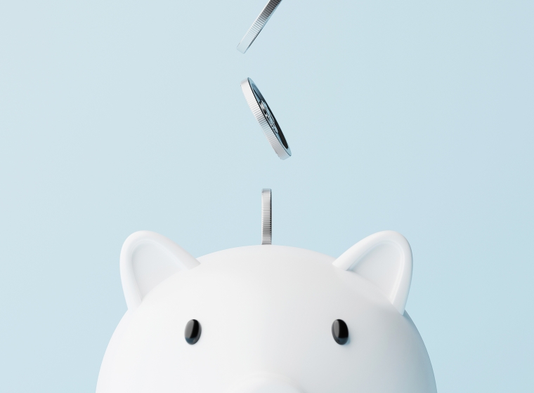 An image of coins falling into a piggy bank as a depiction of the benefits on financial planning