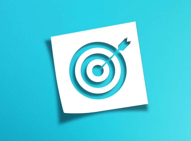 Image of a target on a vibrant blue background as a metaphor for investing goals
