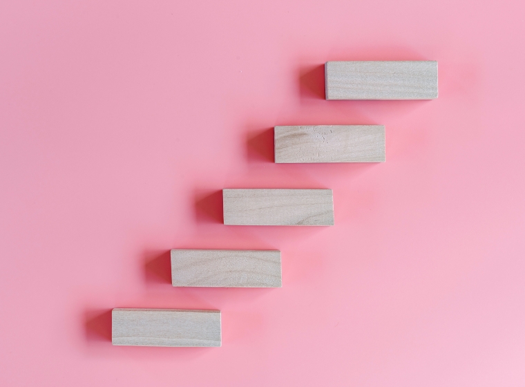 Vibrant pink background with white stairs ascending, representing potential investment returns