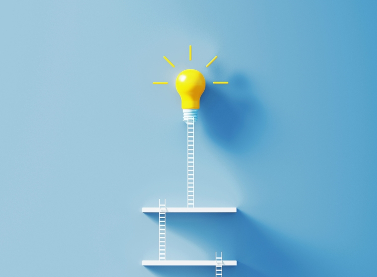 Small white ladders leading to a bright yellow lightbulb, creating a modern scene
