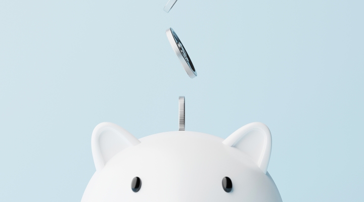 An image of coins falling into a piggy bank as a depiction of the benefits on financial planning