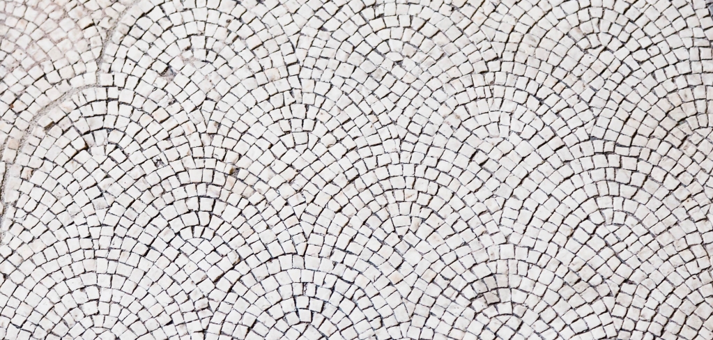 Overlapping stone tiles in a repeating pattern representing community.