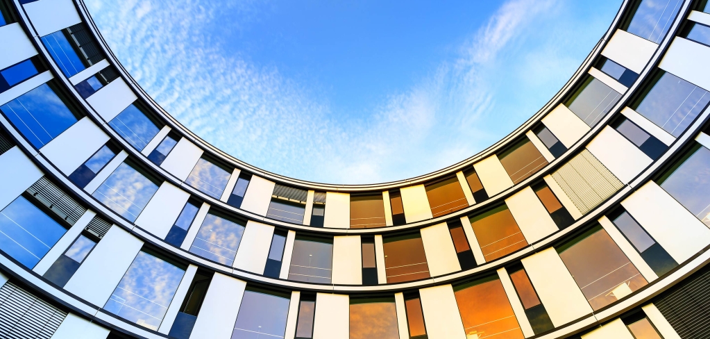 Colorful windows lined up with a bright blue sky representing community.