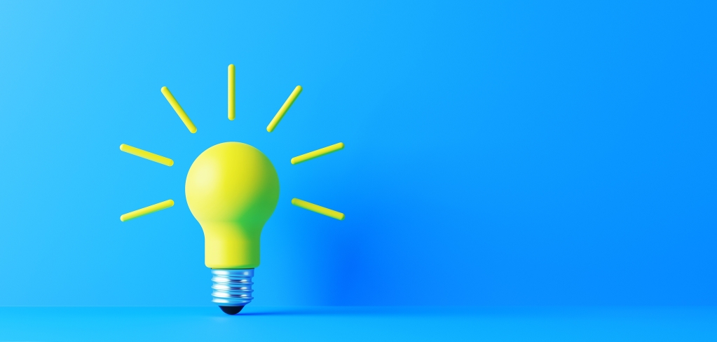 A bright yellow lightbulb radiates ideas on a blue background representing data flow