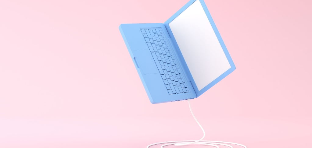 A blue laptop bounces across a pink background representing digitization