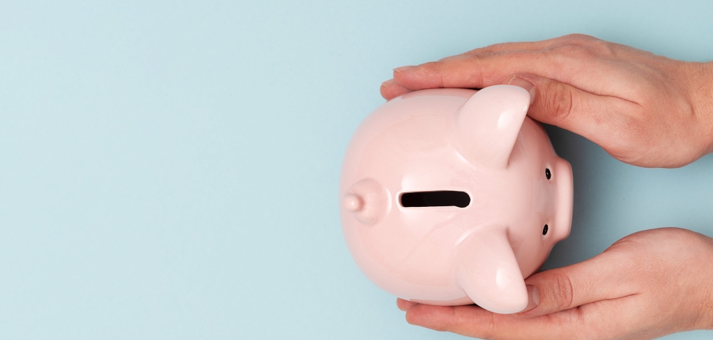 Two hands cradling a piggy bank, depicting the importance of financial planning