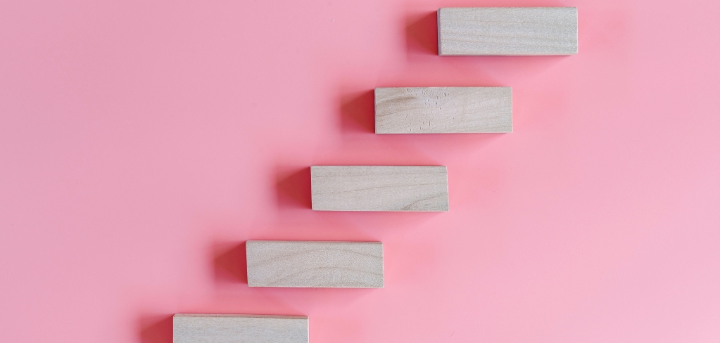 Vibrant pink background with white stairs ascending, representing potential investment returns