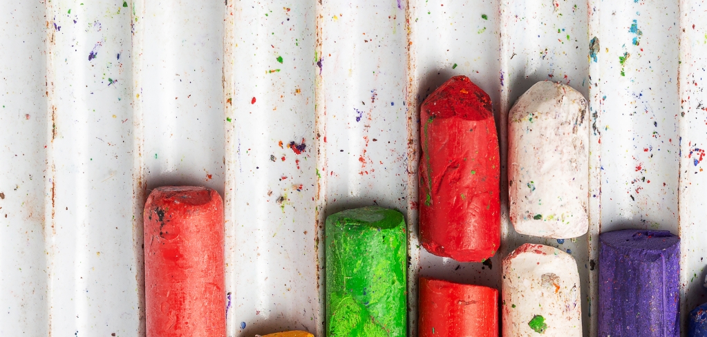 A tray of different colors of chalk representing inclusion