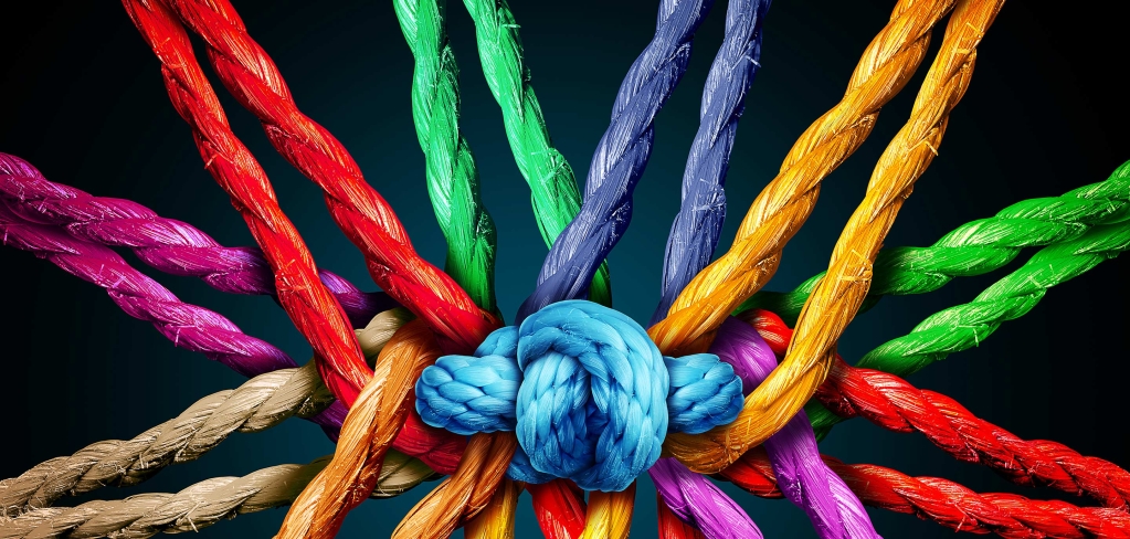 A rainbow of colorful ropes connect in the center to form one bright blue knot, showing the power of integrating multiple ideas.