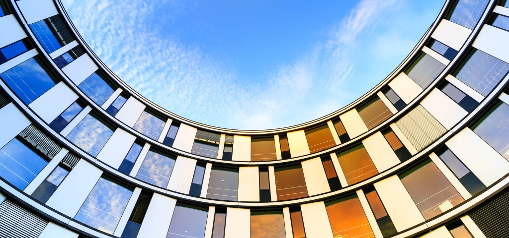 Colorful windows lined up with a bright blue sky representing community.