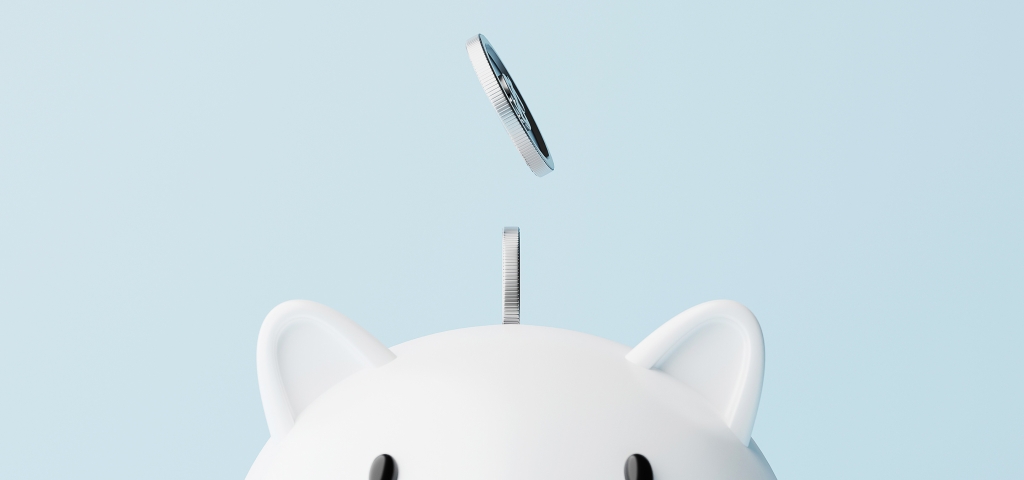 An image of coins falling into a piggy bank as a depiction of the benefits on financial planning