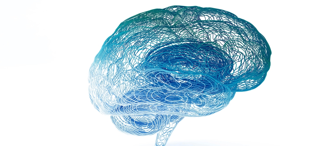 Hundreds of blue and green threads swirl and mingle together forming the shape of a brain