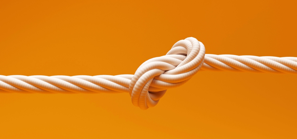 A strong knot in a white rope on a gold background represents the strength of partnerships.