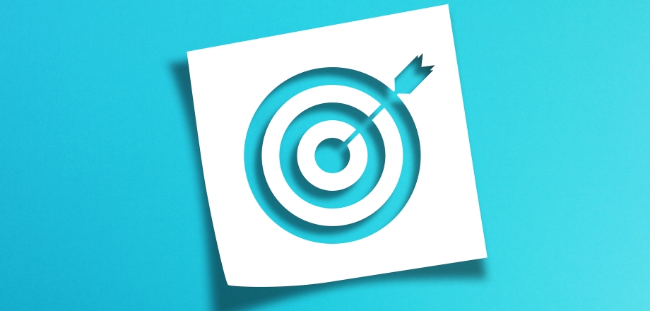 Image of a target on a vibrant blue background as a metaphor for investing goals
