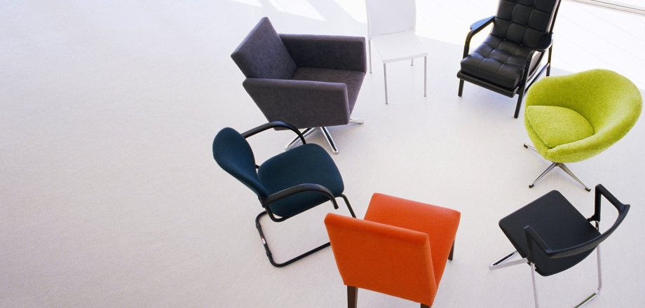 Office chairs of all kinds are in a tight circle, suggesting diverse teams working closely together